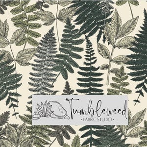 May include: Fabric with a botanical design featuring various fern and leaf illustrations in shades of green and gray on a cream background. The fabric includes the text "Tumbleweed Fabric Studio" in a rectangular label.