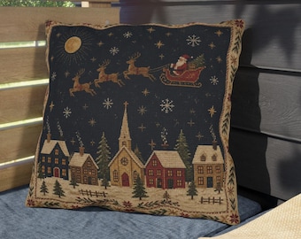 Cojín navideño de exterior con trineo de Papá Noel y renos en un pueblo invernal, estilo vintage, Navidad primitiva.