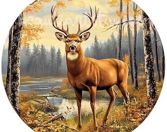 May include: A brown and white deer stands in a forest clearing with a stream in the background. The deer has large antlers and is looking directly at the viewer. The forest is filled with fall foliage in shades of yellow, orange, and red.