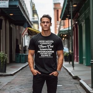 May include: A black t-shirt with white text that reads "I never dreamed I would be a Super Cool Computer Programmer but here I am killing it!"