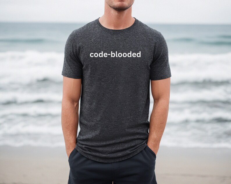 a man is standing on the beach wearing a t - shirt that says code -