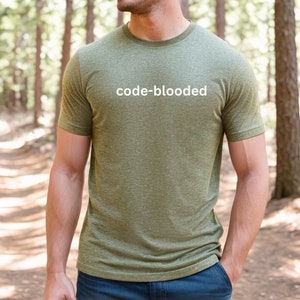 a man standing in the woods with a skateboard