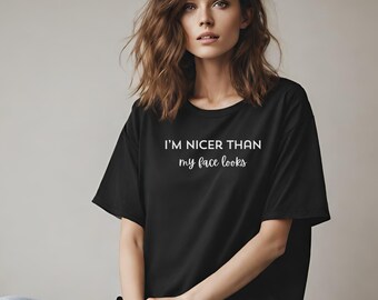 May include: A black t-shirt with white text that reads "I'm nicer than my face looks".