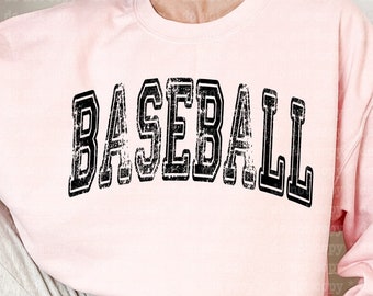 May include: A pink sweatshirt with the word "BASEBALL" printed in black distressed lettering.
