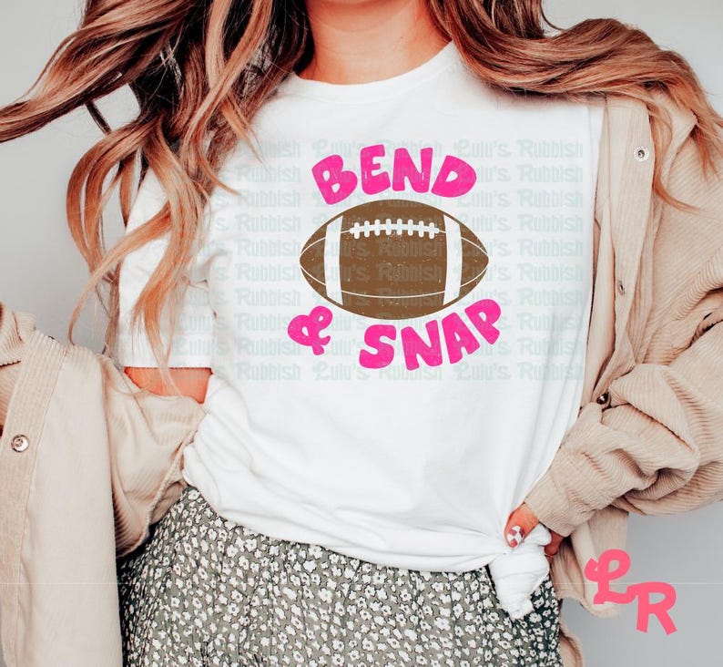 May include: White t-shirt with the text "Bend & Snap" in pink letters and a brown football graphic.