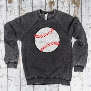 May include: A dark gray sweatshirt with a white and red glitter baseball graphic.