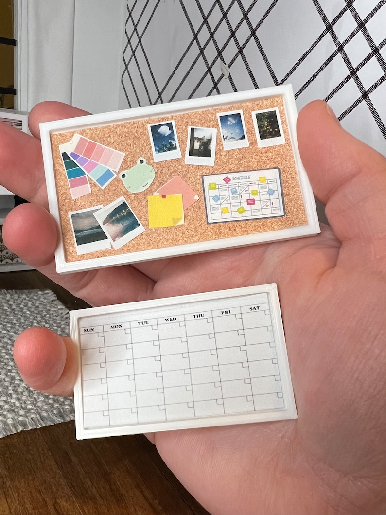 May include: A white corkboard with a frog, a color palette, photos, and a schedule planner. Below is a white dry erase calendar with the days of the week labeled.