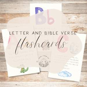 May include: A set of alphabet flashcards with watercolor illustrations and Bible verses. The flashcards feature the letters A, B, and C with corresponding verses from the Bible. The letters are in pastel colors and the verses are printed in black text.