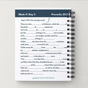 May include: A spiral-bound notebook with a white cover featuring a fill-in-the-blank exercise. The top of the page has the text "Week 4 | Day 3" and "Proverbs 25:7-8". The notebook is on a white surface.