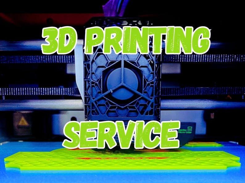 May include: A 3D printer in operation, with the words "3D PRINTING SERVICE" in green, outlined in white. The printer is creating a neon green object on a blue surface. The printer's mechanical components are visible in the background.