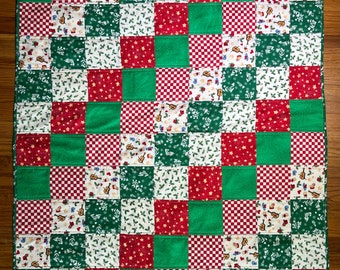 This 100% cotton quilt was handmade in my home. The theme is Christmas/Holiday. A one-of-a-kind quilt. No two quilts in my store are alike.