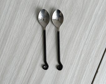 Dos pequeñas cucharillas de azúcar de metal martillado con motivo de caracol, elegantes accesorios de mesa y decoración refinada, un artículo inusual.