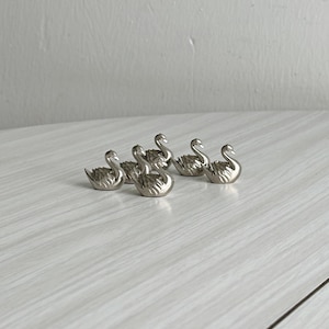 Zilveren metalen zwanen als plaatskaarthouders, elegante tafeldecoratie voor een bruiloft, gastenkaarthouders, elegant diner, Frans servies