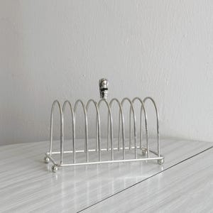 Shiny silver metal toast rack, tulip flower handle, chic breakfast table decor, elegant vintage tableware
