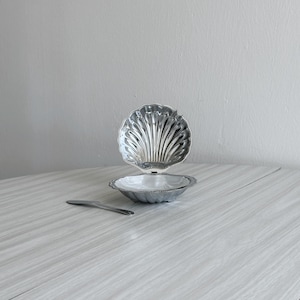 Metal butter dish with lid and spoon, caviar pot, shell design, shiny metal, chrome metal tableware