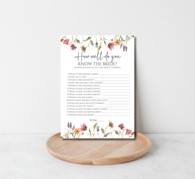May include: A printable bridal shower game with a floral border. The game asks guests to answer questions about the bride, such as her middle name, age, birthday, and favorite food. The game includes a space for guests to write their answers and a total score.