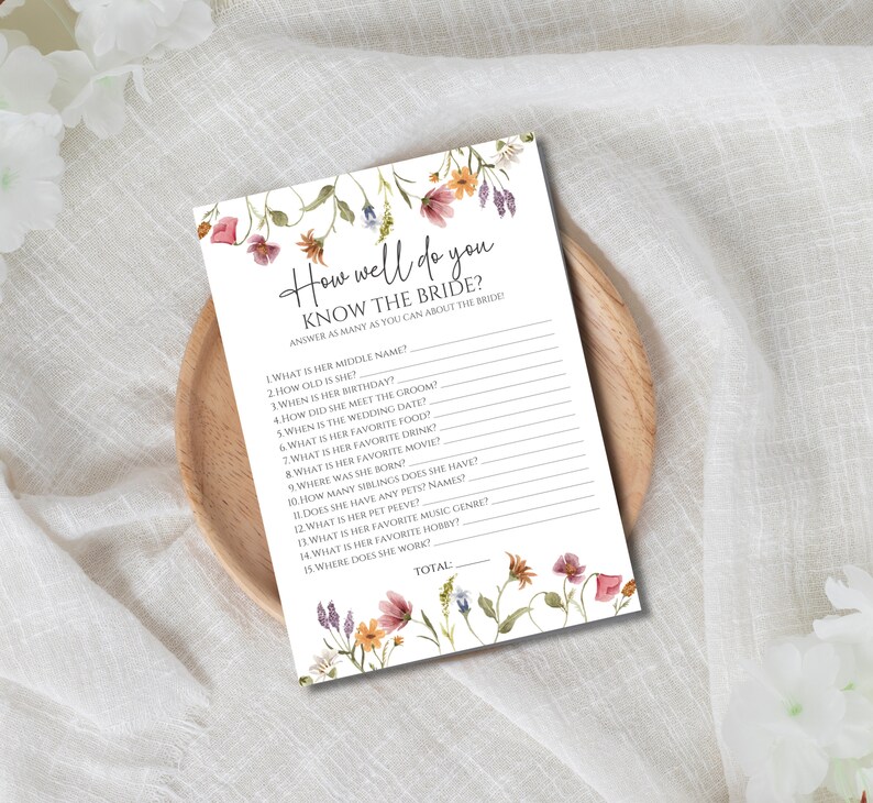 May include: A printable bridal shower game with a floral design. The game asks guests to answer questions about the bride, such as her middle name, birthday, and favorite movie. The game includes a space to calculate the total number of correct answers.