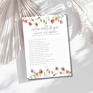 May include: A printable bridal shower game with a floral design. The game asks guests to answer questions about the bride, such as her middle name, birthday, and favorite food. The game includes a space for guests to write their answers and a total score.