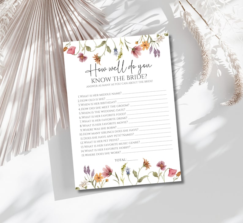 May include: A printable bridal shower game with a floral design. The game asks guests to answer questions about the bride, such as her middle name, birthday, and favorite food. The game includes a space for guests to write their answers and a total score.