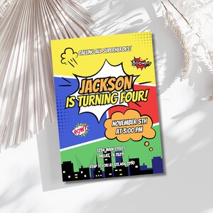 May include: A colourful comic book style birthday invitation for a superhero themed party. The invitation says "Calling all superheroes! Jackson is turning four!" with a date and time of "November 5th at 3:00 PM".