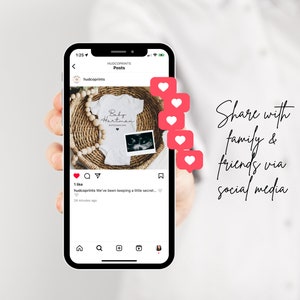 May include: A smartphone screen displaying a social media post announcing a pregnancy. The post features a white onesie with the text "Baby Hartman" and a sonogram photo. The post has received one like and a comment that reads "We've been keeping a little secret..." The post is accompanied by a series of red heart icons.
