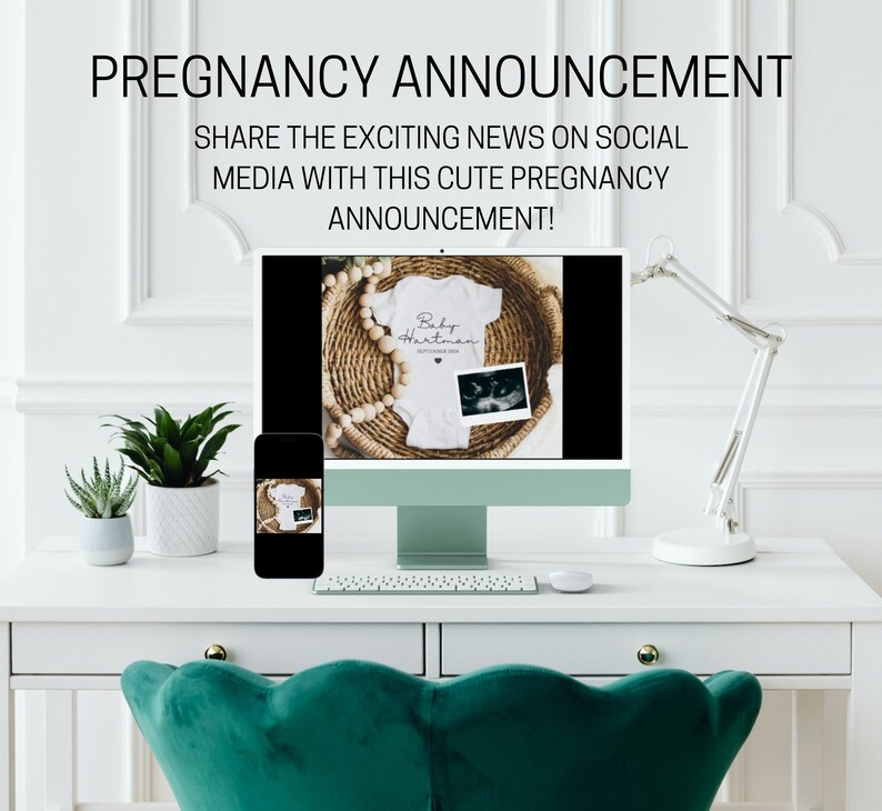 May include: A computer screen shows a mockup of a white onesie with the text "Baby Hartman" and a sonogram image. The onesie is in a wicker basket with wooden beads. A smartphone with a similar image is on a white desk with a keyboard and a lamp.