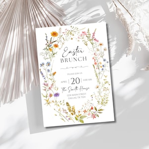 May include: A floral-themed invitation for an Easter brunch. The invitation features a wreath of watercolor wildflowers in shades of pink, blue, yellow, and green. The text reads "Easter Brunch" with the date "April 20" and time "11:00 AM". The location is "The Smith House" with the address "1234 Main Street, Dallas, TX 75211".