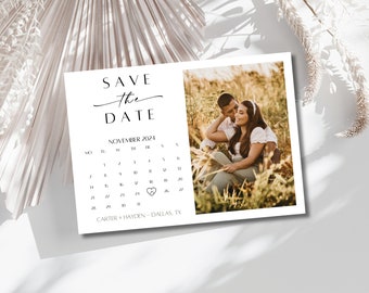 May include: Save the Date card with a calendar featuring November 2024 with a heart marking the 26th. The card also includes a photo of a couple in a field and the text "CARTER + HAYDEN - DALLAS, TX".