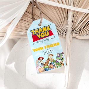 May include: A blue and yellow thank you tag with the text "Thank You for making my birthday special! Your Friend Carter" and a cartoon image of characters from the Toy Story movie franchise.