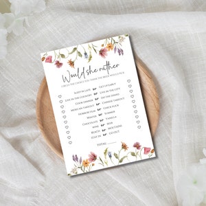May include: A printable bridal shower game with a floral design. The game asks guests to guess the bride's preferences by circling their choice between two options. The game includes questions like "Sleep in late or get up early?" and "Cook dinner or do the dishes?"