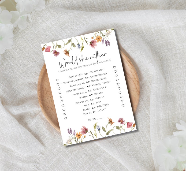 May include: A printable bridal shower game with a floral design. The game asks guests to guess the bride's preferences by circling their choice between two options. The game includes questions like "Sleep in late or get up early?" and "Cook dinner or do the dishes?"