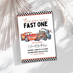 May include: A white invitation card with a red and black checkered border features a red and black car illustration. The text reads "This year was a FAST ONE" and "Cole's 1st Birthday!" with details for the event.
