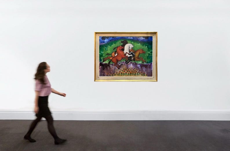 May include: A framed painting depicting several horses in motion, set against a backdrop of green foliage and a blue sky. The artwork features a gold frame and is displayed on a white wall. A person is walking in front of the painting.