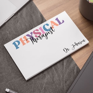 May include: White card with the text "PHYSICAL Therapist" in colorful letters and "Dr. Johnson" in black cursive writing.
