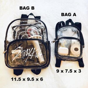 May include: Two clear plastic backpacks with black trim and adjustable straps. The larger backpack is labelled "Bag B" and measures 11.5 x 9.5 x 6 inches. The smaller backpack is labelled "Bag A" and measures 9 x 7.5 x 3 inches.
