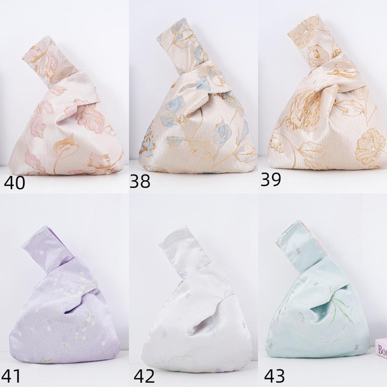 May include: Six fabric knot bags in various colors and floral patterns. The bags are numbered 38, 39, 40, 41, 42, and 43. The bags are made of a shiny fabric and have a unique knot closure at the top.