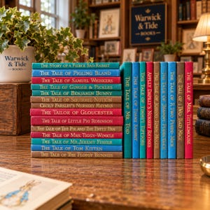 May include: A collection of hardback books with colourful spines featuring gold embossed titles including The Tale of Peter Rabbit, The Tale of Benjamin Bunny, and The Tale of Mrs. Tittlemouse, arranged in two stacks on a wooden surface.