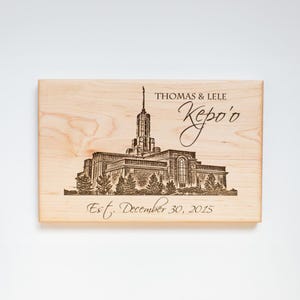 May include: A wooden plaque with an engraved image of a temple and the text "Thomas & Lele Kepo'o Est. December 30, 2015".