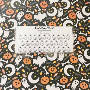 May include: A white sheet with a black border and the text "Let's Boo This! Mini Savings Challenge" with 48 small ghost stickers. The sheet is on a black background with a repeating pattern of orange pumpkins, white moons, yellow candy corn, white bones, and white stars.