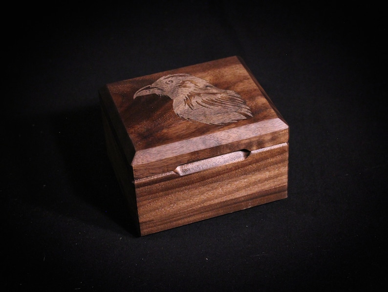 Walnut Deck Box with lid closed, raven engraving on lid shown.