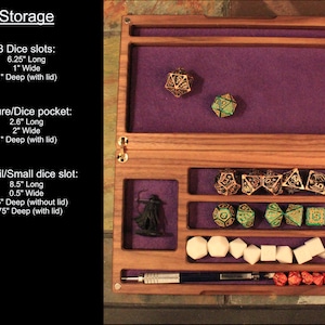 May include: A wooden box with a purple felt interior and compartments for storing dice, figures, and pencils. The box has three dice slots, a figure/dice pocket, and a pencil/small dice slot. The box is 6.25 inches long, 1 inch wide, and 1 inch deep.