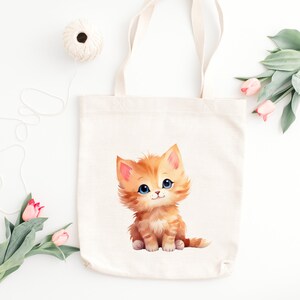 May include: A white canvas tote bag with a cute orange kitten illustration. The kitten has blue eyes and is sitting on its hind legs with its front paws raised.