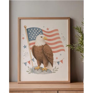 May include: A framed watercolor print featuring an American bald eagle with a white head and brown body, standing before a waving American flag. The artwork includes stars, fireworks, and bunting in red, white, and blue.