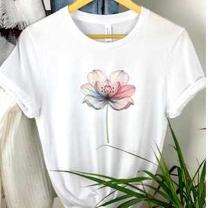 May include: White t-shirt with a colorful, abstract flower design.