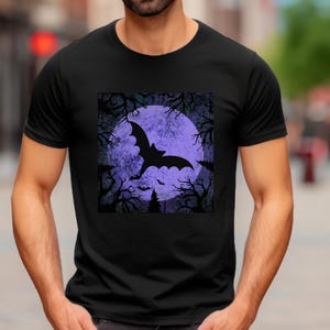 May include: Black t-shirt with a graphic print of a bat flying in front of a purple moon. The moon is surrounded by trees and the background is a dark purple.
