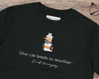 May include: Black t-shirt with a stack of cats and the quote 'One cat leads to another.' by Ernest Hemingway.