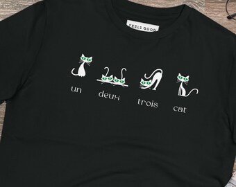 May include: Black t-shirt with a white graphic of cats and the French words "un", "deux", "trois", and "cat".