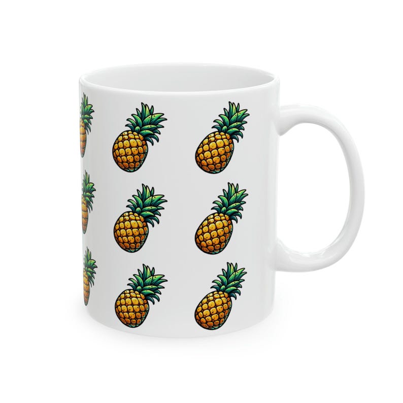 A white ceramic mug with a repeating pattern of pineapple illustrations on its side.