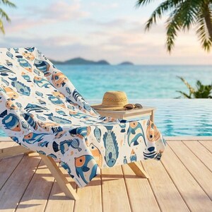 A wooden deck overlooking a pool, with a colorful towel and a hat on a small table, and palm trees in the background.