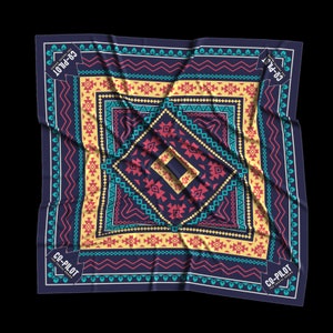 May include: A blue bandana with a colorful geometric pattern and the text "CO-PILOT THE TRAVEL BRAND" in white.